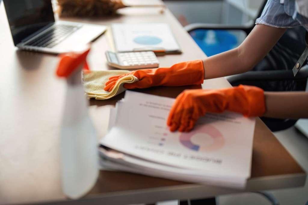 Asian woman cleaning in work room at home. Young woman housekeeper cleaner use a cloth to wipe equipment for working. concept housekeeping housework cleaning.