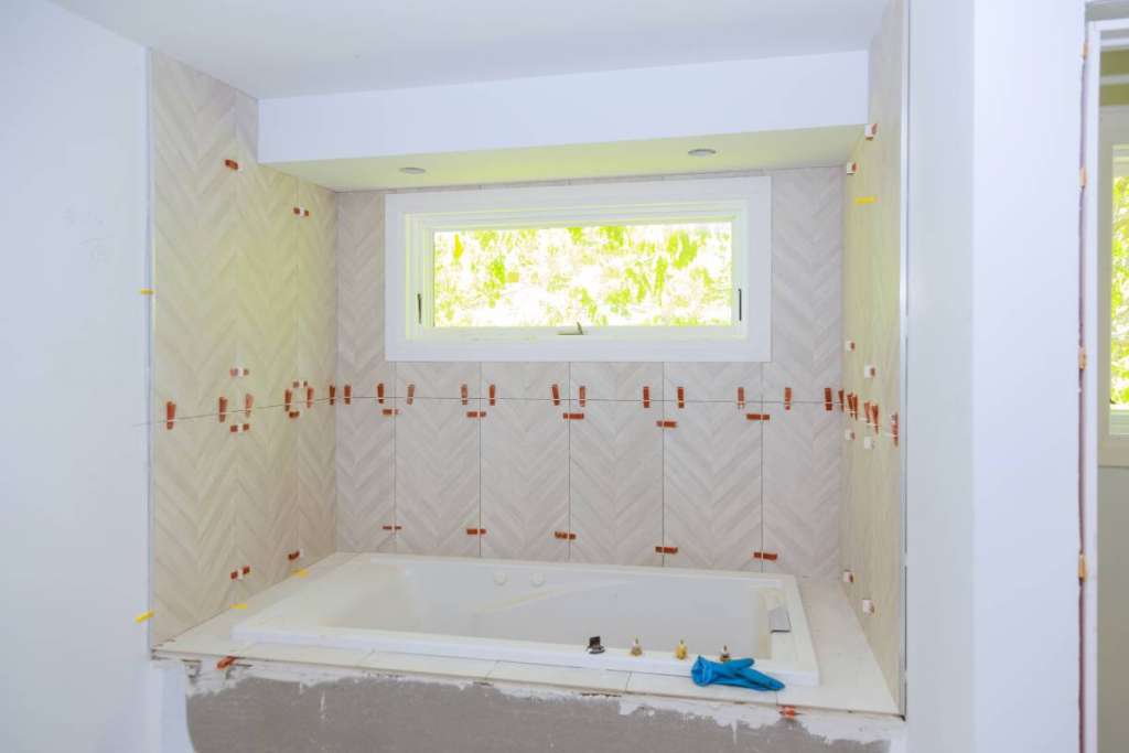 Construction installing ceramic tile on reconstruction of bathroom during or renovation