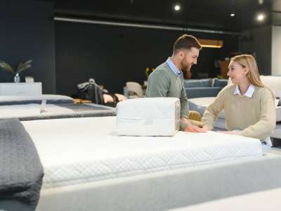 Happy couple choosing furniture in store.